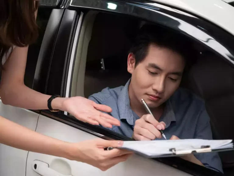 young-asian-man-is-talking-sales-manager-while-choosing-car-dealership